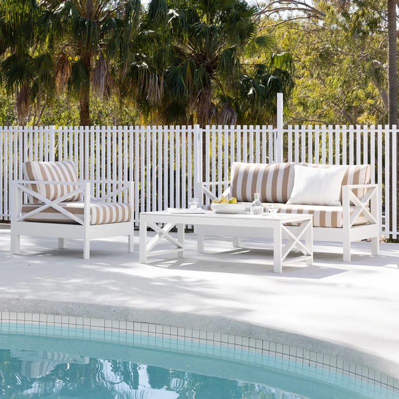 Outdoor sofa with custom-size white and beige striped pillows and cushions, UV resistant and backed by a 5-year warranty, perfect for durable outdoor comfort